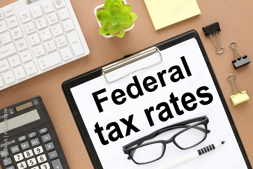 federal tax rates. brown background top view of the layout of ...