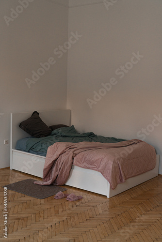 cozy white bed with a pink cover