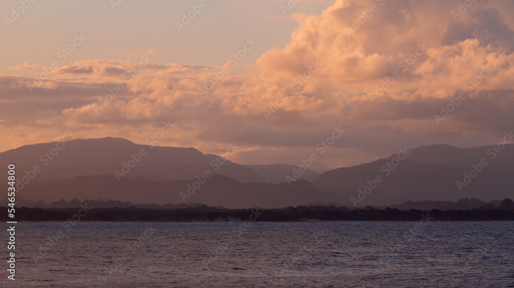 Sunset view of mountain layers on the coast.
