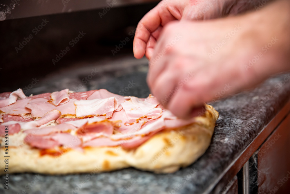 hand of chef baker making pizza at kitchen. The process of making pizza. cooking italian pizza hand of chef baker making pizza at kitchen. The process of making pizza. cooking italian pizza