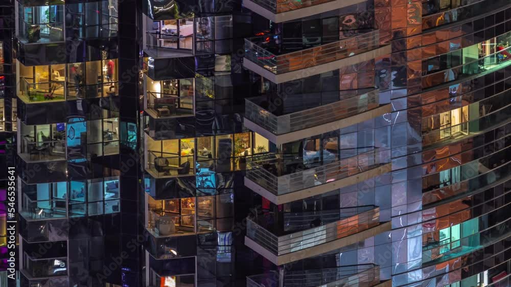 Night view of many glowing windows in apartment residential tower timelapse. High rise illuminated skyscraper with lights in rooms Night view of many glowing windows in apartment residential tower timelapse. High rise illuminated skyscraper with lights in rooms