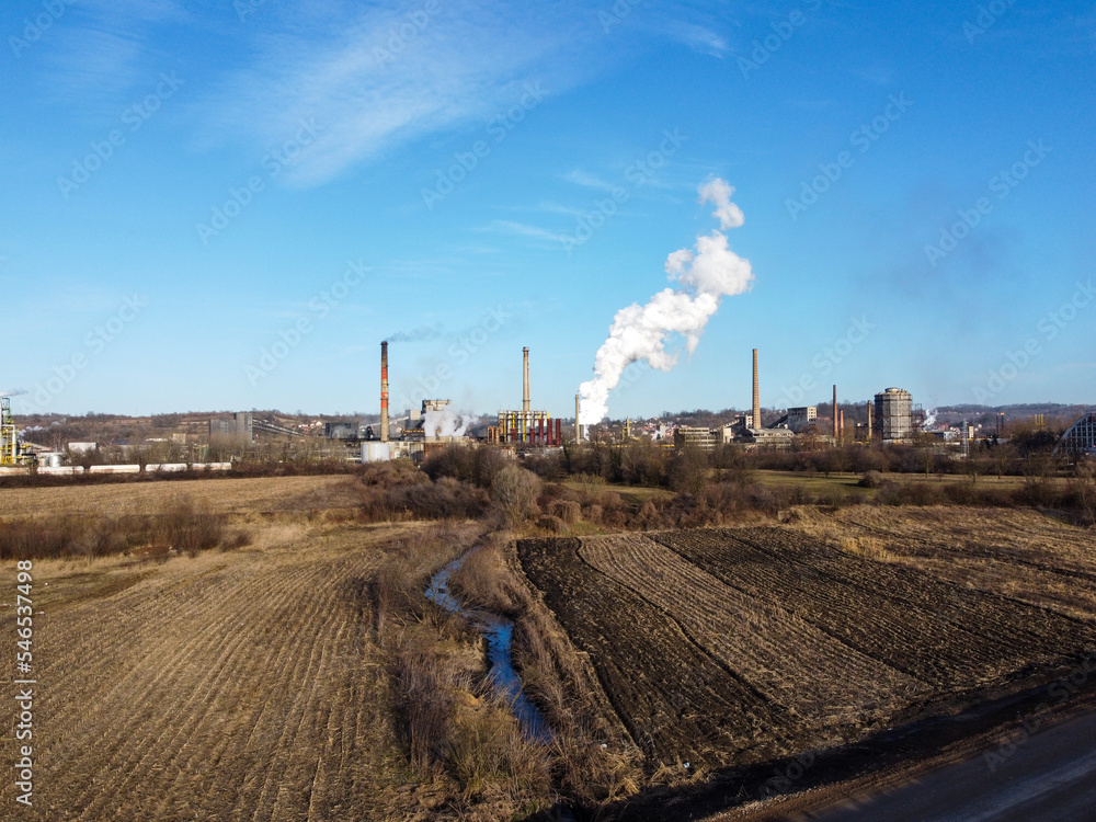 Factory chimney blowing pollution in environment. Industrial air pollution from smokestacks, aerial drone view. Factory chimney blowing pollution in environment. Industrial air pollution from smokestacks, aerial drone view.
