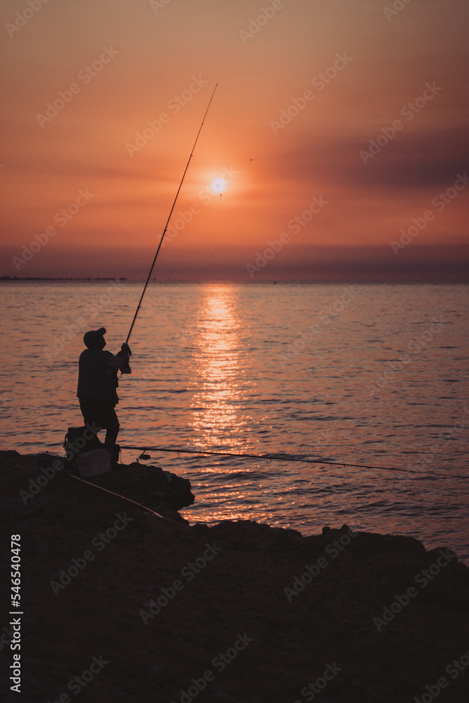 fisherman at sunset in the ebro delta