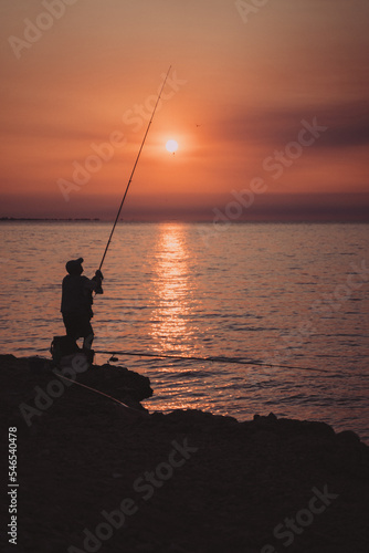 fisherman at sunset in the ebro delta