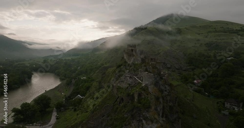 Atskuri Fortress On The Rocky Hill Over Kura Riverbank On A Misty Morning In Georgia. Aerial  Drone Shot photo
