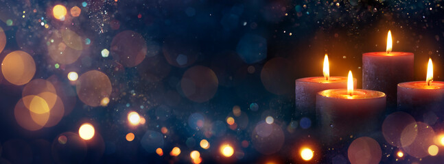 Advent Candles Burning In The Dark With Abstract Defocused Lights