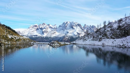 Mountain Lake in Dolomies mountains. Clear mountain water reflecting the snowy peaks of the mountains. Ritorto Lake In Dolomites. Lago Ritorto in Trentino region in Italy. Madonna di Campiglio  photo