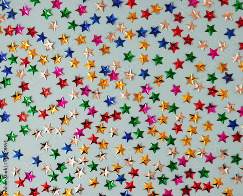 Pattern made of stars confetti on blue background. Flat lay concept. Parti time.
