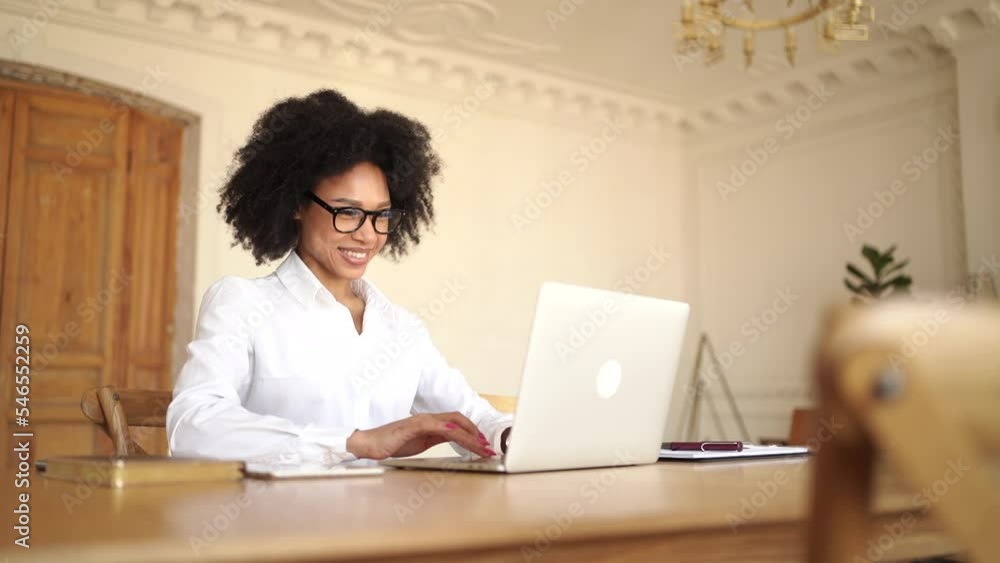 A female designer is smiling and working in the office using a laptop. Manager surf the internet for information, coworking space. A female designer is smiling and working in the office using a laptop. Manager surf the internet for information, coworking space.
