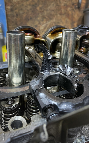 Close-up of huge metal or steel shaving on a broken car engine. Detail of damaged automobile motor. Serious problem. Maintenance, service, technical issues of vehicles. Old car component.