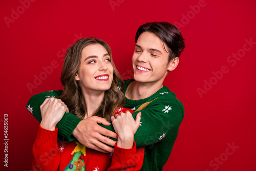Fotografia Photo of cheerful lovely couple wife husband wear ugly jumper hugs look each oth