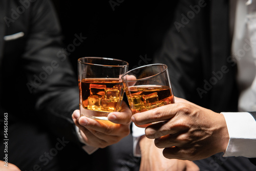 Businessmen in suits drinking Celebrate whiskey