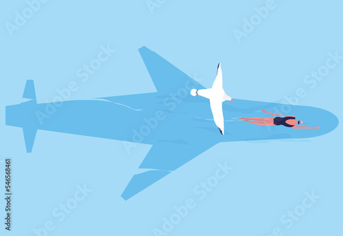 A seagull spots a speedy woman swimming in the shadow of a plane flying over the bird