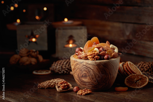 Dried fruits and assorted nuts on a wooden table. © Igor Normann