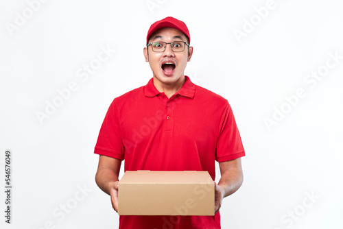 Cheerful asian man in red cap and t-shirt, holding parcel box. Courier pick-up package from client, shipping box