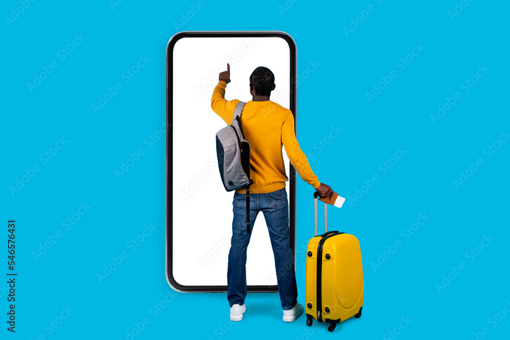 African american man traveller standing by huge smatphone, touching screen African american man traveller standing by huge smatphone, touching screen