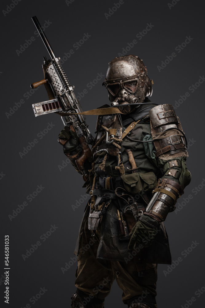 Studio shot of military man in spirit of post apocalypse with shotgun staring at camera.