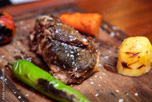 Grilled steak on a wooden plate