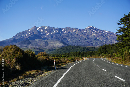 road to mountain and blue sky in background in summer and autumn at tongariro national park, taupo, new zealand, curve street on right frame 
