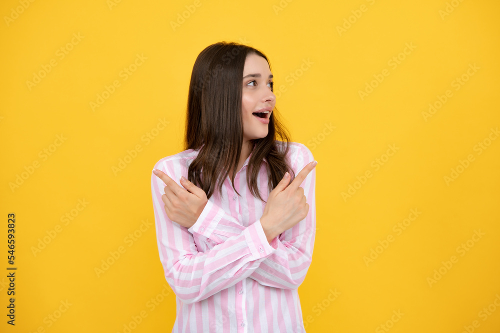 Woman point at copy space, showing copyspace pointing. Promo, girl showing advertisement content gesture, pointing with hand recommend product. Isolated yellow background. Woman point at copy space, showing copyspace pointing. Promo, girl showing advertisement content gesture, pointing with hand recommend product. Isolated yellow background.