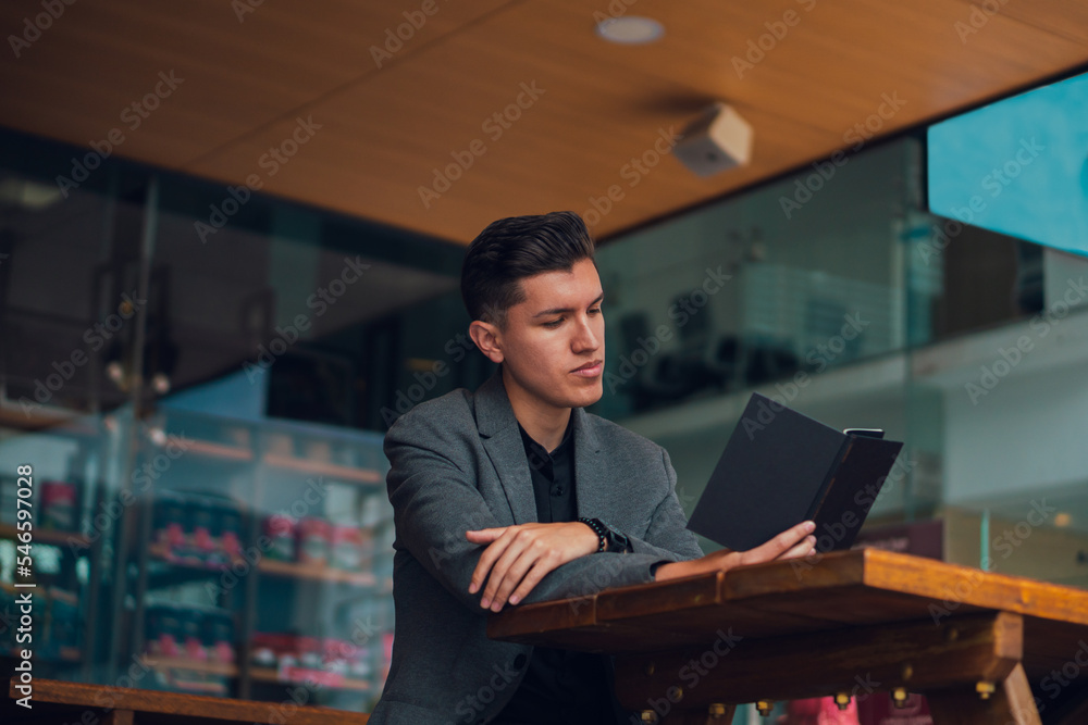 Focused man with notebook in cafe Focused man with notebook in cafe