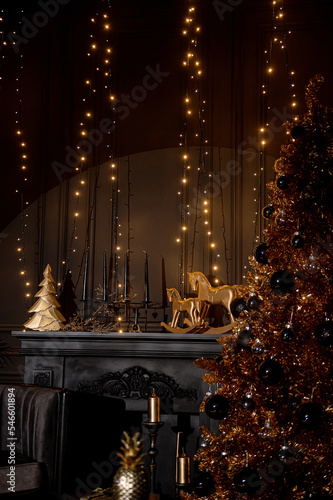Merry Christmas and Happy Holidays!Beautiful black modern living room decorated for Christmas.Chrystmas Luxury black style living room interior with sofa decorated chic , golden style.Selective focus.