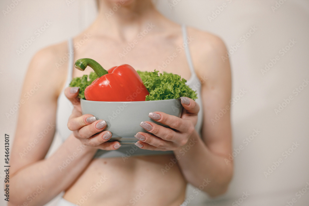 Cropped photo of woman with lots of healthy fresh vegetables on a plate Cropped photo of woman with lots of healthy fresh vegetables on a plate