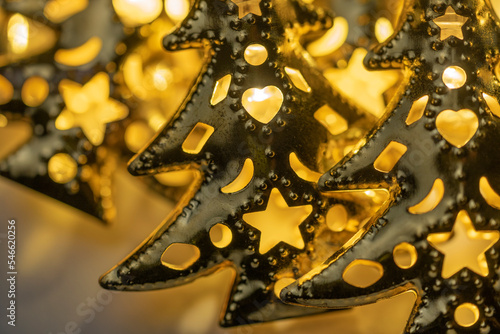 Wallpaper Mural Sparkling sequins and garlands in the form of golden Christmas trees with ornaments and figures close-up, Christmas concept. Warm and lamp environment Torontodigital.ca