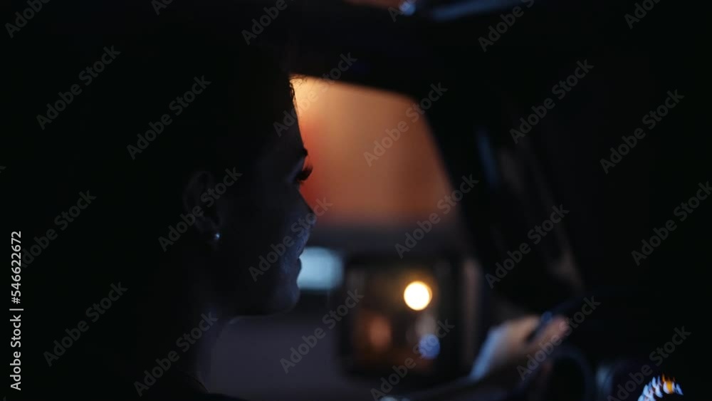 Woman Glances At Her Passenger While Driving Her Car At Night Woman Glances At Her Passenger While Driving Her Car At Night