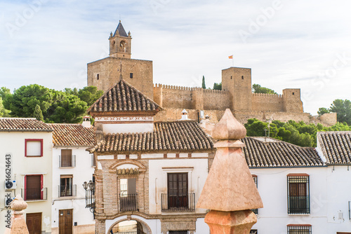 Alcazaba de Antequera. old medieval castle. stone walls, towers, stone buildings. horizontally and vertically, sunlight, blue sky and clouds photo