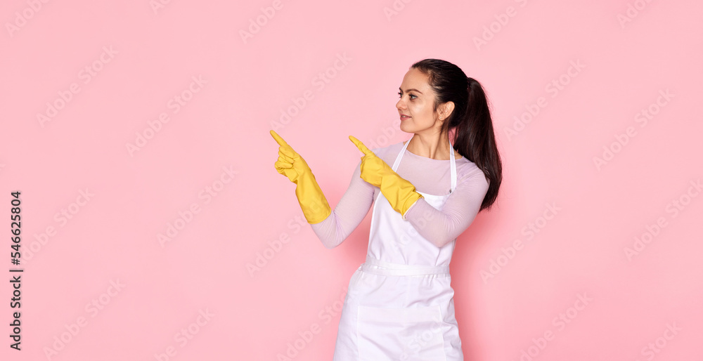 woman in rubber gloves pointing fingers aside at copyspace woman in rubber gloves pointing fingers aside at copyspace