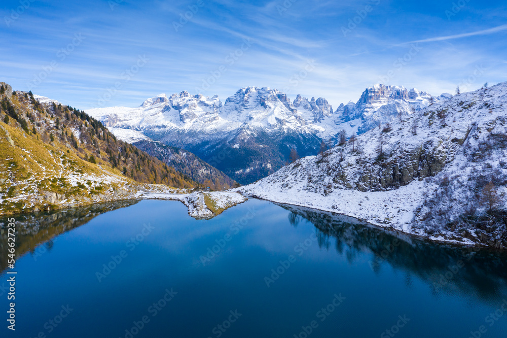 Mountain Lake in Dolomies mountains. Clear mountain water reflecting the snowy peaks of the mountains. Ritorto Lake In Dolomites. Lago Ritorto in Trentino region in Italy. Madonna di Campiglio 