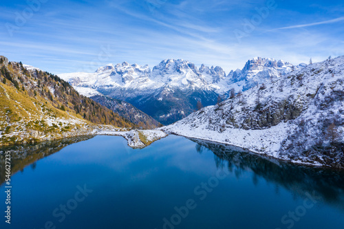 Mountain Lake in Dolomies mountains. Clear mountain water reflecting the snowy peaks of the mountains. Ritorto Lake In Dolomites. Lago Ritorto in Trentino region in Italy. Madonna di Campiglio 