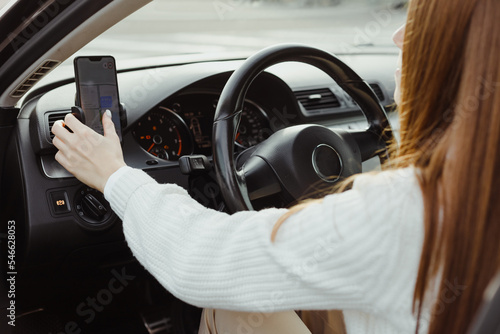 Woman driving car Use smartphone with navigator, showing route