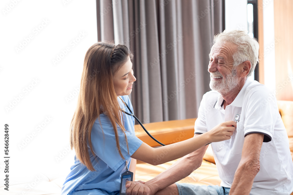 Obraz premium Caring nurse with senior man sitting in the bedroom . caucasian man. Discussing. Caring caregiver and senior citizen. Nurse helping senior patient . Young nurse helping elderly man