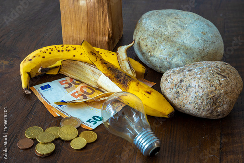 Euro coins and money with a glass lightbulb and a bananas