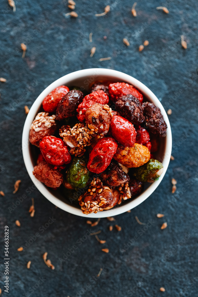 assorted candied peanuts in a ceramic bowl assorted candied peanuts in a ceramic bowl