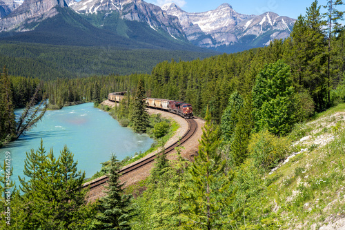 Freight train going through Morants Curve on a sunny summer day in Banff National Park Canada photo