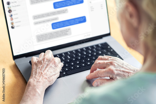 Chat messages in laptop of an old woman. Love fraud scam of catfish. Elder person in online conversation with family. Grandma group messaging. Communication in social media. Customer support chatbot. photo
