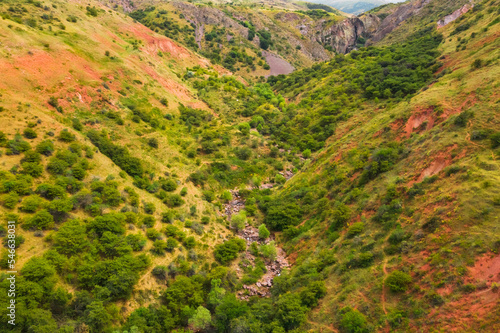 Canyon Akkum in the South Kazakhstan region. An ancient canyon with red clay in the Kazygurt region. Sacred Muslim place for Kazakhs Akkum valley photo