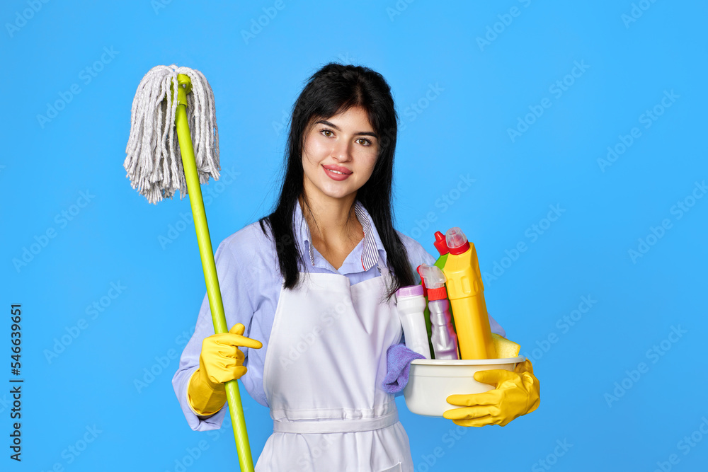 woman in gloves holding bucket of detergents and mop