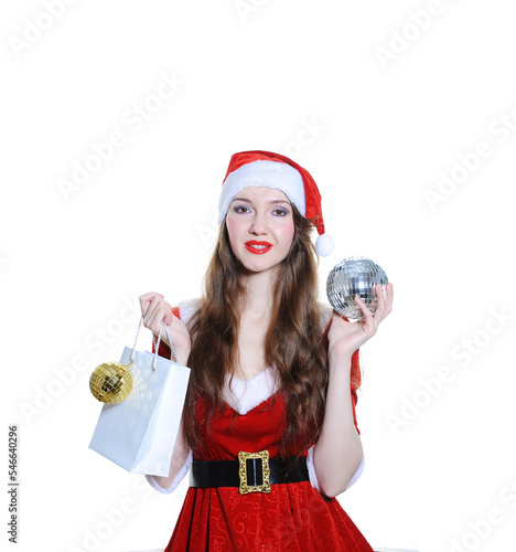 Girl dressed as Santa with a gift bag and disco ball on a white background isolated. Christmas, New Year holiday concept