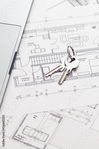 key and architectural blueprint map or drawing of house or future home at landlord real estate agent