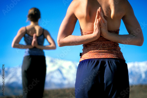 Two women in yoga pose, Owen's Valley, California. photo
