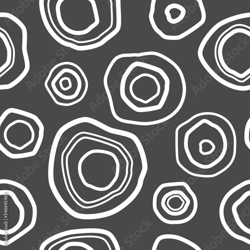 Seamless pattern with white shabby circles on grey background. Kaleidoscope wallpaper. Decorative hand drawn ornament. Vector illustration. Ethnic style print