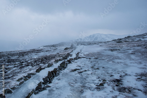 Clouds over snowy landscape of Alpine Garden Trail on Mount Washington, New Hampshire, USA photo