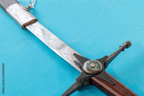 Fotografiet Cossack sword in a scabbard, close-up on a blue background