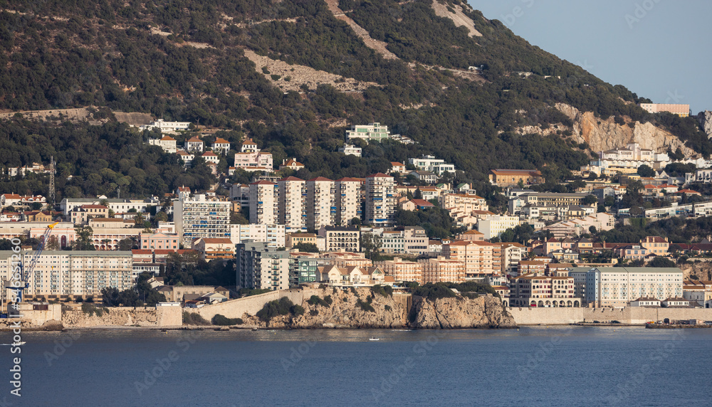 City Buildings, Homes and Mountain by the Sea. Sunny Sky. Gibraltar, United Kingdom.