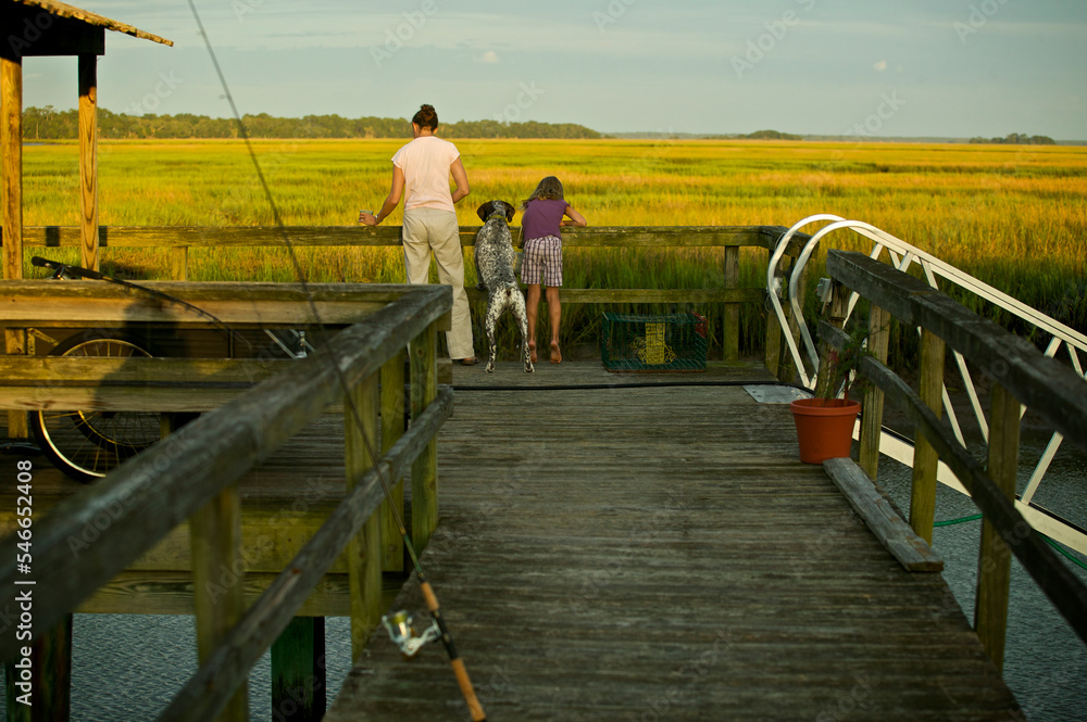 Mother and daughter with dog at end of dock. Crescent, Ga. Mother and daughter with dog at end of dock. Crescent, Ga.