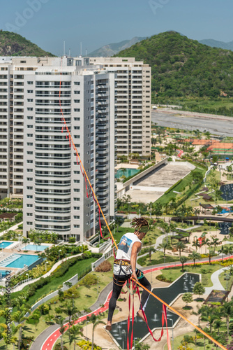 Man highlining between skyscrapers, Olympic Village, BarraÂ DaÂ Tijuca, RioÂ deÂ Janeiro, Brazil photo